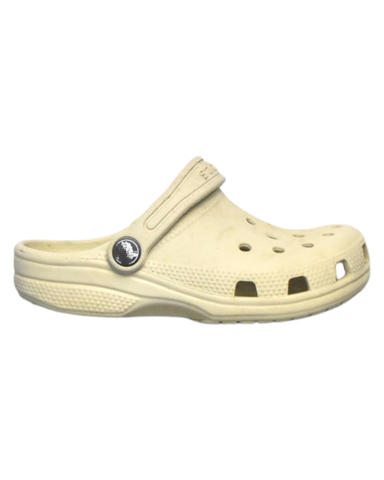 A Beige Slip Ons from Crocs in size 5T for boy. (Front View)